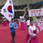 A South Korean athlete carries the country’s national flag at the opening ceremony for the 2013 Asian Cup and Interclub Weightlifting Championship in Pyongyang, North Korea.