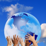 Hands touching a globe --- Image by © Royalty-Free/Corbis