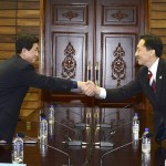 Head of the North Korean working-level delegation Park shakes hands with his South Korean counterpart Lee during talks in the truce village of Panmunjom